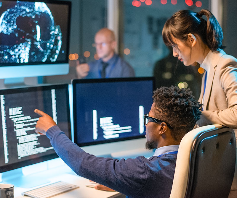 Team working in a control room setting with multiple large screens displaying data and visuals—reflecting the company's AI infrastructure capabilities